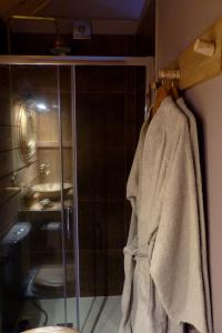 a bathroom with a shower and a towel on a rack at Le bain de campagne in Montereau +10 photos