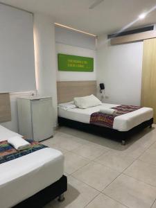 Postel nebo postele na pokoji v ubytování Hotel Calarca Club