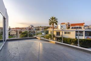 a large balcony with a view of a city at Penthouse with outdoor hottub in Limassol
