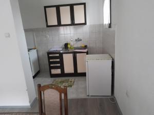 a small kitchen with a sink and a refrigerator at Nebo in Soko Banja