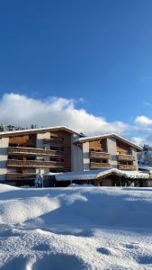 a building with snow in front of it at Hôtel Rent in Megève