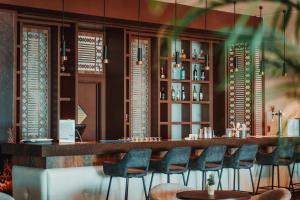 a bar at a restaurant with blue chairs at Real Marina Hotel & Spa in Olhão