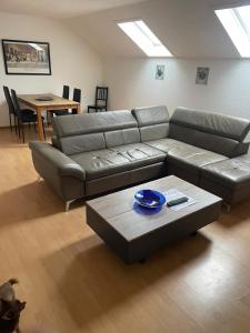 a living room with a couch and a table at Ferienwohnung IDYLL in Niederweiler +19 photos