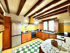 a large kitchen with a table in the middle at Casa rural LA CEÑA in Argüeso