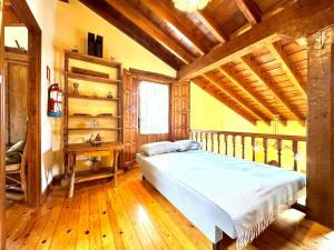 a bedroom with a bed and a wooden ceiling at Casa rural LA CEÑA in Argüeso