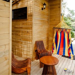 a porch with two chairs and a table and a window at Villa Colombia in Vianí