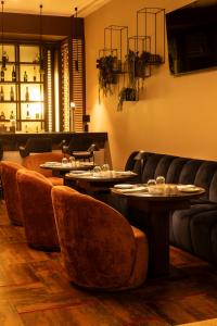a restaurant with couches and tables and chairs at Real Marina Hotel & Spa in Olhão