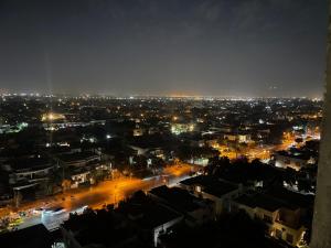 uma vista para uma cidade à noite com luzes em Goldcrest Apartments em Lahore