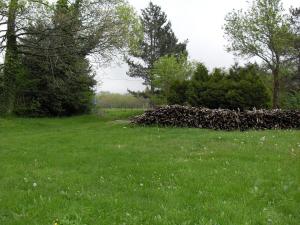 a pile of logs in a field of grass at la source et la sorciere in Pradelles-Cabardès +4 photos