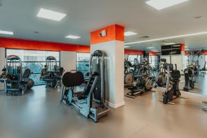 a gym with several treadmills and exercise bikes at Real Marina Hotel & Spa in Olhão