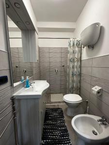 a bathroom with a sink and a toilet and a mirror at Melinda e Marlene in Ioppolo