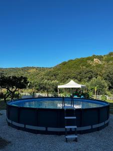 a swimming pool with a ladder in the middle at Melinda e Marlene in Ioppolo