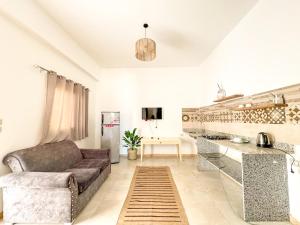 a living room with a couch and a kitchen at Sea Breeze Dahab in Dahab
