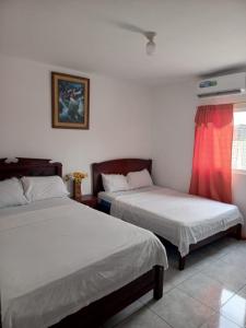 Postel nebo postele na pokoji v ubytování Hotel Rumbo al Sol
