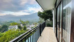 a balcony with a view of a mountain at WonderStay Holiday Bungalow - Kandy in Kandy