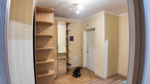 a room with a room with shelves and a hallway at Apartment Promenade EXPO in Astana