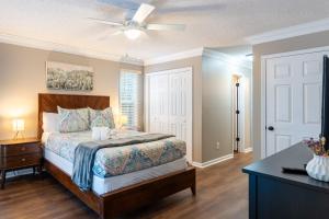 a bedroom with a bed and a ceiling fan at 8-Guest Cozy Escape with Fire Pit & Hot Tub! in Pawleys Island