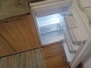 an empty refrigerator with its door open in a kitchen at Горішній Пасічна Зелена Вулецька завод Іскра Біля лісу Новий Львів in Lviv