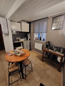 a kitchen with a wooden table in a room at Da Pietro e Sandra in La Spezia