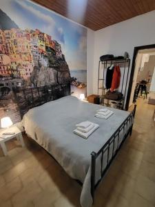 a bedroom with a large bed with a painting on the wall at Da Pietro e Sandra in La Spezia