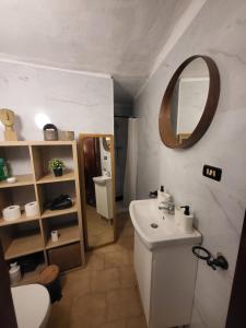a bathroom with a sink and a toilet and a mirror at Da Pietro e Sandra in La Spezia +66 photos