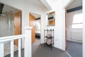a room with a walk in shower and a bedroom at Harrison's Cottage in Llandegla +5 photos