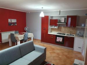 a living room with a couch and a kitchen with a table at Holiday Home Villa Relax in Palermo