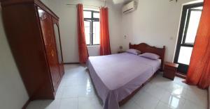 a bedroom with a large bed and two windows at Rama Villas Mauritius in Trou aux Biches +35 photos