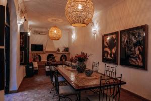 a dining room with a table and chairs at Riad Bamaga in Marrakesh