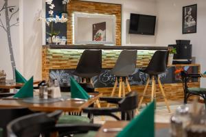 a restaurant with tables and chairs and a fireplace at Hotel Stoiser Graz -Parkplatz inbegriffen! in Graz