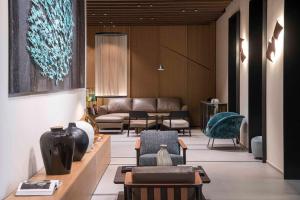 a lobby with a couch and chairs and a table at Europa Palace in Sanremo