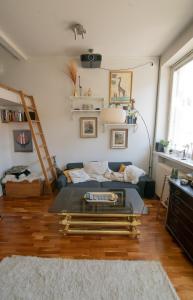 a living room with a couch and a table at Giraffe Loft in Helsinki