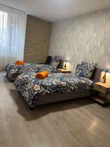 a bedroom with two beds and two tables with lamps at Tain centre -T3- wine themed apartment in Tain-lʼHermitage