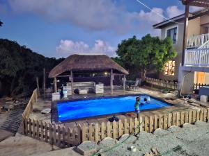 a person standing in front of a swimming pool at KaMageba Palace in Durban