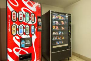a coca cola vending machine next to a soda machine at Motel 6 Crowley, LA in Crowley