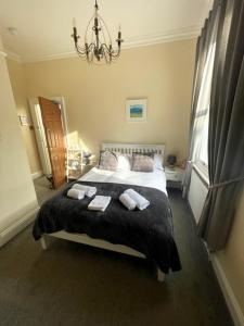 a bedroom with a bed with two towels on it at The Florence Guest House in Whitby