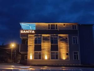 a santaica building with lights on at night at sanita otel in Bayramşah