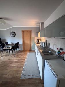 a kitchen and dining room with a table and chairs at Top výhľad !-Apartmán 10-Nová Lesná in Nová Lesná