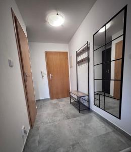 a hallway with a door and a bench in a room at Top výhľad !-Apartmán 10-Nová Lesná in Nová Lesná