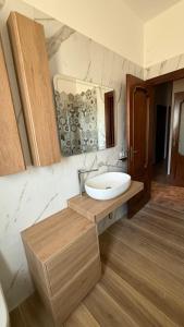 a bathroom with a sink and a mirror at Stella Marina in Montesilvano +34 photos