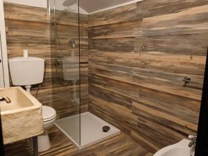 a bathroom with a toilet and a glass shower at Matese Home in San Massimo +15 photos