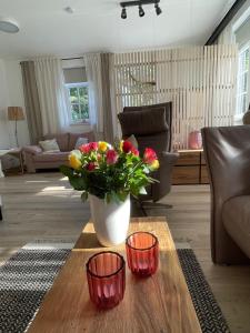 a living room with a vase of flowers on a table at Thüringer Wald-Zauber in Zella-Mehlis +42 photos