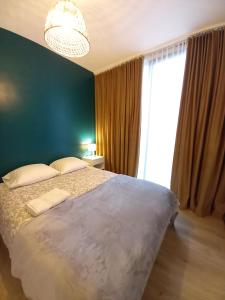 a bedroom with a large bed and a large window at Comfy Stay 9052 in Ghent