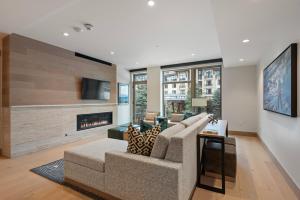 a living room with a couch and a fireplace at Snowmass Lux Getaway by Snowmass Vacations in Snowmass Village