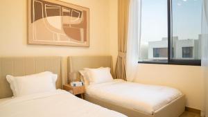 a hotel room with two beds and a window at Luxury Villa In Yas in Abu Dhabi +19 photos