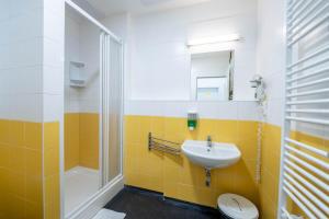 a bathroom with a sink and a shower and a toilet at Drunken Monkey Hostel in Prague +37 photos