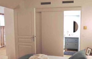a bedroom with a door leading to a bathroom at Quartier de la plage in Roquebrune-Cap-Martin +4 photos