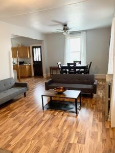 a living room with a couch and a table at LG Lofts - 2 bedroom unit in Kiel close to Road America Elkhart Lake in Kiel +2 photos