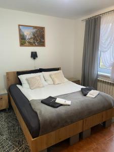 a bedroom with a bed with two towels on it at Zajazd na Liwskich Mostach in Węgrów +35 photos
