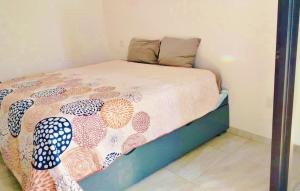 a bedroom with a bed with a comforter on it at Marina Cerritos Coral del Mar - 4 Albercas de Lujo - 1 Min Playas in Mazatlán +14 photos